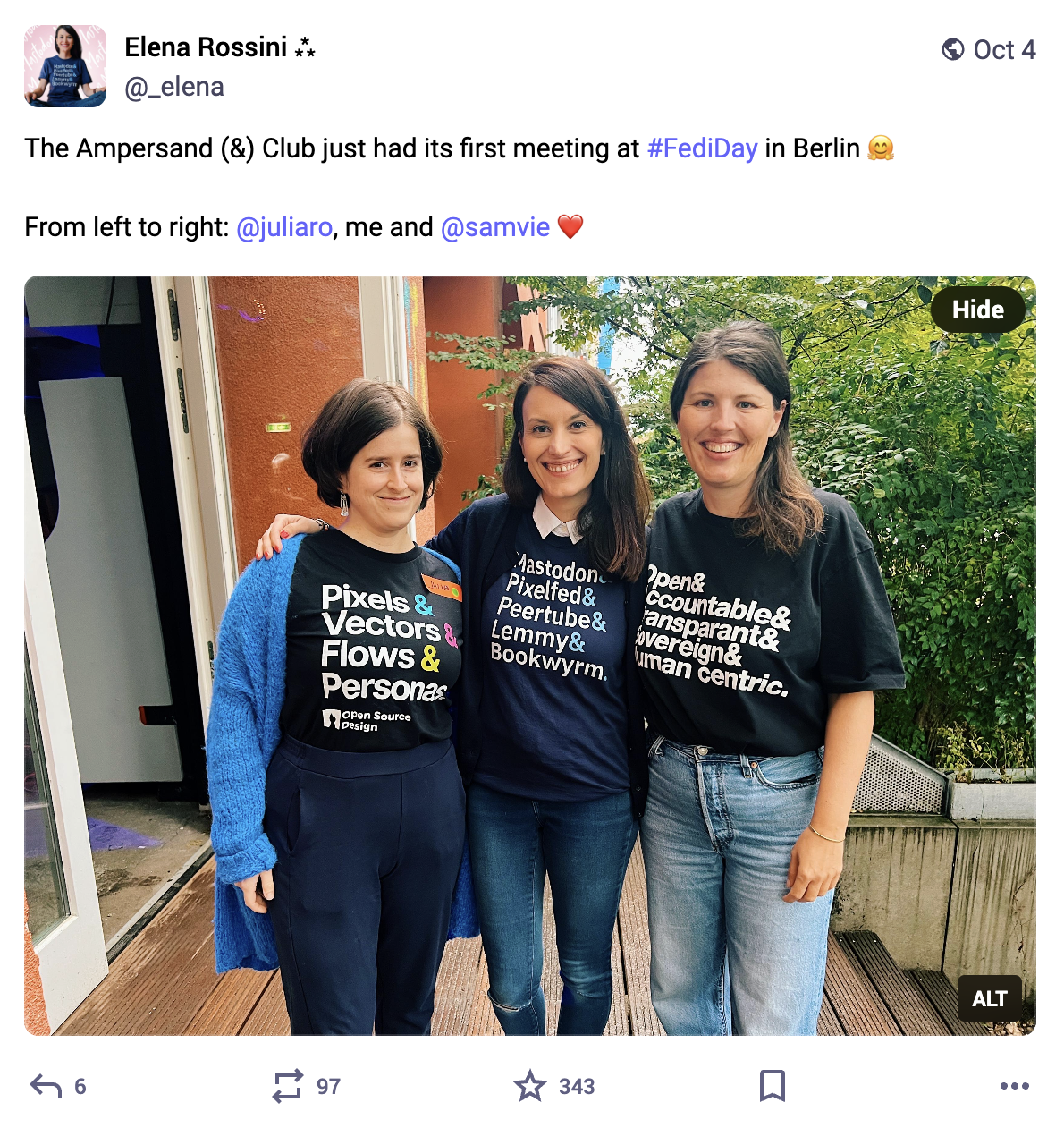 the screenshot of a toot that reads "The Ampersand (&) Club just had its first meeting at #FediDay in Berlin. From left to right: @juliaro, me and @samvie". The photo shows three women: Julia wearing the t-shirt Pixels & Vectors & Flows & Personas… me wearing the t-shirt Mastodon & Pixelfed & Peertube & Lemmy & Bookwyrm… and Samvie wearing the t-shirt Open & Accountable & Transparent& Sovereign & Human Centric